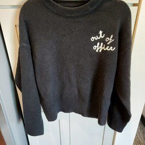 black "out of office" sweater